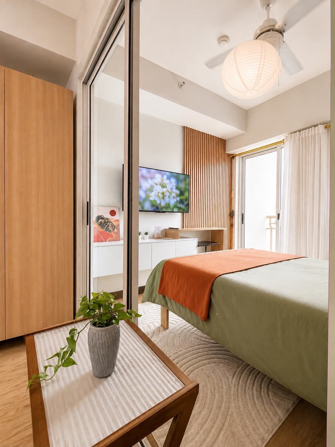 Bedroom with television and balcony access